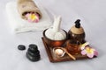 Hot compress herbs, Atmosphere candle, honey glass on Herbals tray for therapy massage. Natural black stone and Plumeria flowers