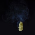 Hot cooked macaroni over a dark background