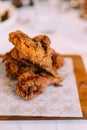 Hot and crispy golden Fried Chicken wings and wingsticks. Served on wooden plate Royalty Free Stock Photo