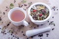 Hot cup of herbal and blackberry tea with white mortar with pestle Royalty Free Stock Photo