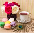 Hot cup of red tea and colored cakes Royalty Free Stock Photo
