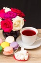 Hot cup of red tea and colored cakes Royalty Free Stock Photo