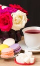 Hot cup of red tea and colored cakes Royalty Free Stock Photo