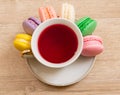 Hot cup of red tea colored cakes Royalty Free Stock Photo