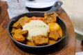 Hot curry rice in black pan with beef and vegetables on food table