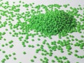 Hot cutting type green masterbatch granules on white background, masterbatch is used as product colorant in plastic industry