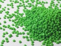 Hot cutting type green masterbatch granules on white background, masterbatch is used as product colorant in plastic industry