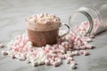 Hot dark chocolate with whipped cream and marshmallows on light marble background Royalty Free Stock Photo