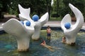 On a hot day, children bathe in the pool of the central park fountain