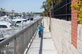 Hot days, fun days. Energetic child run on promenade. Joyful boy have fun