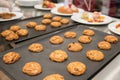 Hot delicious oatmeal cookies on baking tray from oven