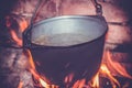 Hot delicious steaming food in a cast iron pot