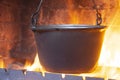 Hot delicious steaming food in a cast iron pot