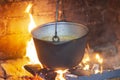 Hot delicious steaming food in a cast iron pot