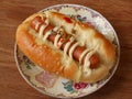 Hot dog bun garnished with cheese and sauerkraut Royalty Free Stock Photo