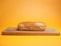 A hot dog bun on a wooden cutting board . Front view Royalty Free Stock Photo