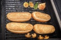 Hot dog buns are heated on a grill on coals. Street food. Royalty Free Stock Photo