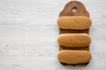 Hot dog buns on wooden board on white wooden table, top view. Flat lay, from above, overhead. Royalty Free Stock Photo