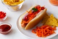 Hot dog with carrot on the white plate Royalty Free Stock Photo
