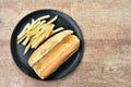 Hot dog with cheese and French fried fast food on dish Royalty Free Stock Photo