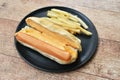 Hot dog with cheese and French fried fast food on dish Royalty Free Stock Photo