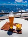 Hot dog with german beer with view of alps mountain range Royalty Free Stock Photo