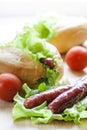Hot dog. Grilled hot dogs with fresh salad lettuce on wooden table. Royalty Free Stock Photo