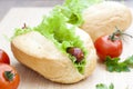 Hot dog. Grilled hot dogs with fresh salad lettuce on wooden table. Royalty Free Stock Photo