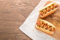 Hot dog with grilled sausage  mustard  and ketchup  onions  and greens on paper background Royalty Free Stock Photo