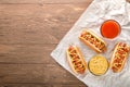 Hot dog with grilled sausage  mustard  and ketchup  onions  and greens on paper background Royalty Free Stock Photo