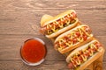 Hot dog with grilled sausage  mustard  and ketchup  onions  and greens on paper background Royalty Free Stock Photo