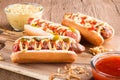 Hot dog with grilled sausage  mustard  and ketchup  onions  and greens on paper background Royalty Free Stock Photo