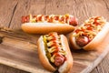 Hot dog with grilled sausage  mustard  and ketchup  onions  and greens on paper background Royalty Free Stock Photo