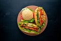 Hot dog and hamburger with cheese, meat and greens on Wooden background. Royalty Free Stock Photo