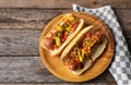 Hot dog with jalapeno pepper and tomato on wooden background