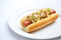 hot dog with relish and onions on a white bun