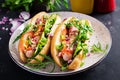 Hot dog with sausage, cucumber, tomato and red onion
