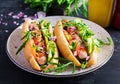 Hot dog with sausage, cucumber, tomato and red onion