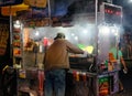 Hot dog stand vendor in New York city, seen cooking hotdogs. Royalty Free Stock Photo