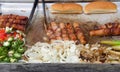 Street vendor grill with hot dogs and onions Royalty Free Stock Photo