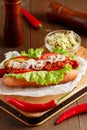 Hot-dog on wooden cutting board Royalty Free Stock Photo