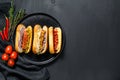 Hot dogs with assorted toppings. Delicious hot-dogs with pork and beef sausages. Black background. Top view. Copy space