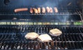 Cheeseburgers and hot dogs on a grill Royalty Free Stock Photo