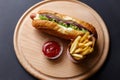 Hot Dogs with French fries and ketchup on wooden plate Royalty Free Stock Photo