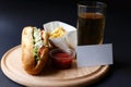 Hot Dogs with French fries and ketchup on wooden plate Royalty Free Stock Photo