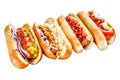 Hot dogs fully loaded with assorted toppings on a tray. Delicious hot-dogs with pork and beef sausages. Isolated on Royalty Free Stock Photo