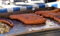 Hot dogs on an outside grill with thermometer in Royalty Free Stock Photo