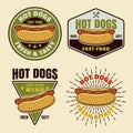 Hot dogs set of four vector colorful emblems, badges, labels, stickers or logos in cartoon style on light background