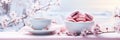 Hot drink and cakes on a wintery holiday setting adorned with pink cherry flowers Royalty Free Stock Photo