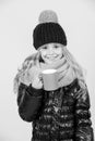 Hot drink in cold weather. Child with blue cup smile on orange background. Tea or coffee break. Girl in hat, pink scarf Royalty Free Stock Photo